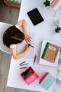 Girl doing homework sitting at a desk Royalty Free Stock Photo