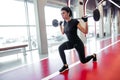 Girl doing lunges with barbell in modern gym Royalty Free Stock Photo