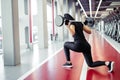 Girl doing lunges with barbell in modern gym Royalty Free Stock Photo