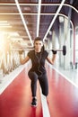 Girl doing lunges with barbell in modern gym Royalty Free Stock Photo