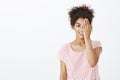 Girl doing makeup showing before and after. Portrait of positive cute dark-skinned woman in striped t-shirt, covering Royalty Free Stock Photo