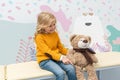 Girl doing neurology examination of teddy bear