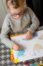 Girl doing paper art work at home