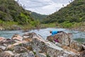 Girl Doing a Plank on Rocks Near Fast River