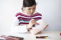 Girl doing SFX makeup on a training rubber head for makeup Royalty Free Stock Photo