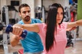 Girl doing shoulder flys with her trainer Royalty Free Stock Photo