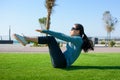 Girl doing situps on the grass, outdoor workout Royalty Free Stock Photo