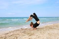 Girl doing sports exercises on beach