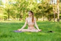 Girl doing stretching exercises outdoors. Young woman practicing yoga Royalty Free Stock Photo