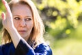 A girl doing tai Chi exercises in a green Park on a Sunny day close up Royalty Free Stock Photo