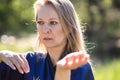A girl doing tai Chi exercises in a green Park on a Sunny day close up Royalty Free Stock Photo