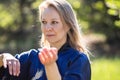 A girl doing tai Chi exercises in a green Park on a Sunny day close up Royalty Free Stock Photo