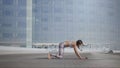 Girl doing upward facing dog pose outdoors. Woman exercising yoga on city street Royalty Free Stock Photo