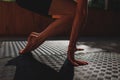 class in nature. women's hands go down and touch the carpet with their palms. close-up of hands and feet on a Royalty Free Stock Photo