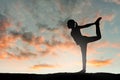 Girl doing yoga excercise at sunset. Royalty Free Stock Photo