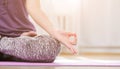 Girl doing yoga indoors in lotus asana Royalty Free Stock Photo