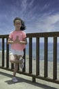 Girl doing yoga meditating with her eyes closed by the sea