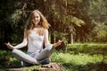 Girl doing yoga in nature. Royalty Free Stock Photo