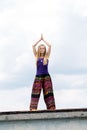 Girl doing yoga on the roof Royalty Free Stock Photo