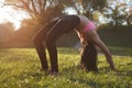 Girl is doing yoga, standing in bridge pose. Setu Bandhasana. with sunset on background Royalty Free Stock Photo