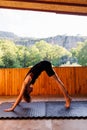 The girl is doing yoga. Young athletic woman trainer practicing yoga instructor individual training. balancing pose, modern gym,