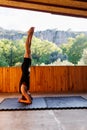 The girl is doing yoga. Young athletic woman trainer practicing yoga instructor individual training. balancing pose, modern gym,