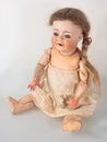 Girl doll with beige dress and ponytail hair