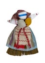 A girl doll made of cloth, with a blue dress, white apron and red belt. Home creativity. Traditional Russian doll