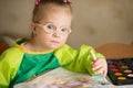 Girl with Down syndrome draws paints Royalty Free Stock Photo