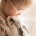 Girl with Down syndrome hugs rabbit