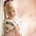 Girl with Down syndrome hugs rabbit