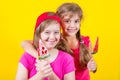 Girl Down syndrome and little girl with large Lollipop Royalty Free Stock Photo