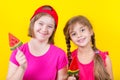 Girl Down syndrome and little girl with large Lollipop Royalty Free Stock Photo