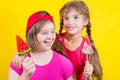 Girl Down syndrome and little girl with large Lollipop Royalty Free Stock Photo