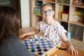 Girl with Down Syndrome playing checkers
