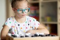 Girl with Down Syndrome playing checkers