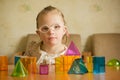 Girl with Down syndrome playing with geometrical shapes Royalty Free Stock Photo