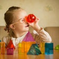 Girl with Down syndrome playing with geometrical shapes Royalty Free Stock Photo