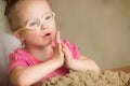 Girl with Down syndrome playing kinetic sand