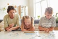 Girl with Down Syndrome Playing Puzzle Game with Family