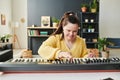 Girl With Down Syndrome Playing Synth Royalty Free Stock Photo