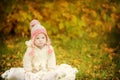 Girl with Down syndrome is resting in autumn park