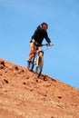 Girl downhill on mountain bike Royalty Free Stock Photo