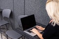 Young business woman working at the computer in cafe. Young girl downshifter working at a laptop, working day.