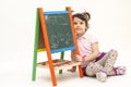 Girl draw flowers, Sun and clouds on black board with chalk Royalty Free Stock Photo