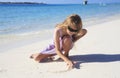 Girl drawing in beach sand Royalty Free Stock Photo