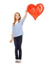 Girl drawing big red heart in the air Royalty Free Stock Photo