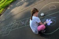 A girl drawing a colorful hopscotch Royalty Free Stock Photo