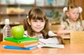 Girl drawing in copybook in classroom