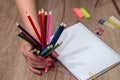 Girl drawing on empty note with colorful pencils Royalty Free Stock Photo